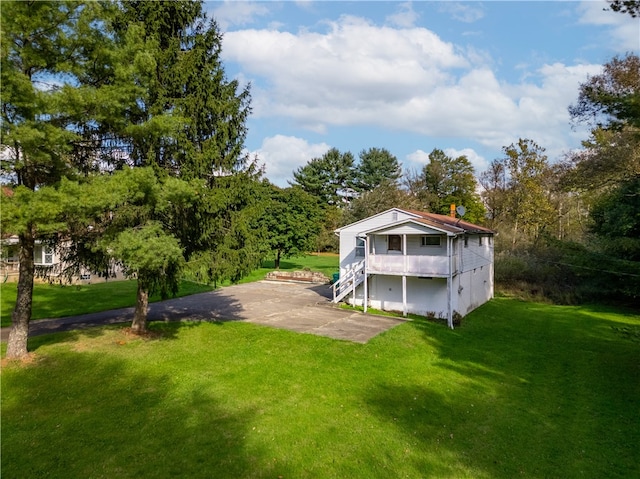 rear view of property featuring a lawn