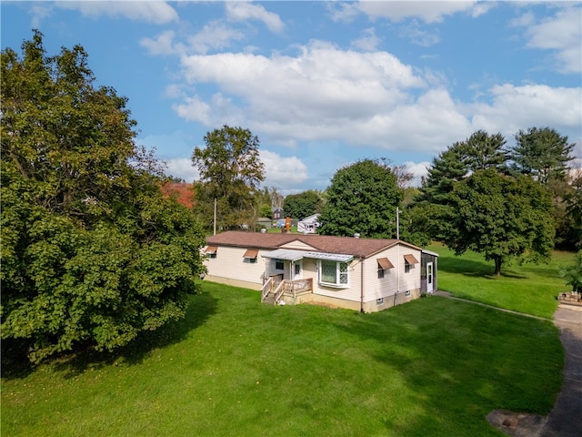 back of house with a lawn