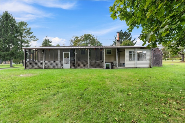 exterior space featuring a sunroom and a lawn