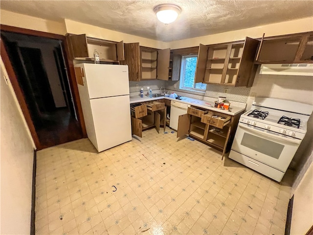 kitchen featuring sink, a textured ceiling, white appliances, and exhaust hood