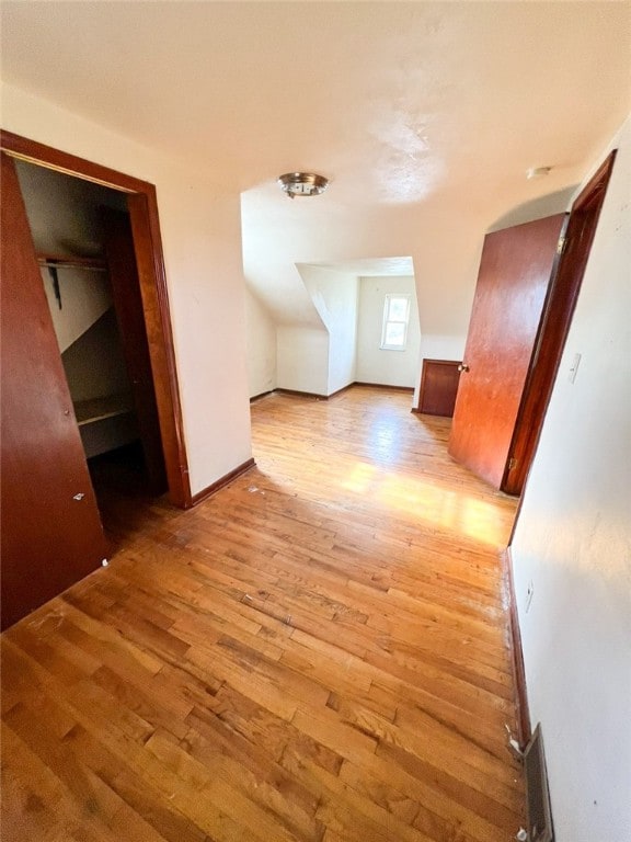 additional living space featuring light hardwood / wood-style flooring