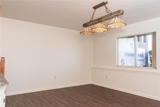 spare room featuring dark wood-type flooring