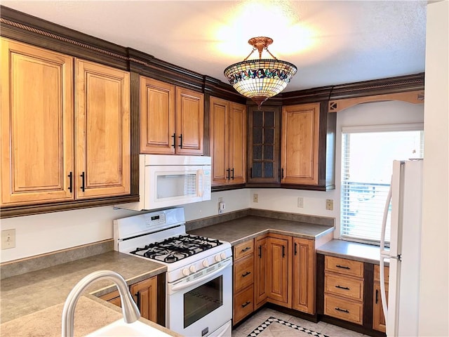 kitchen featuring pendant lighting, white appliances, and light tile patterned floors