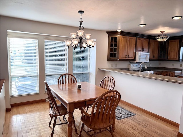 dining room featuring light hardwood / wood-style floors and an inviting chandelier