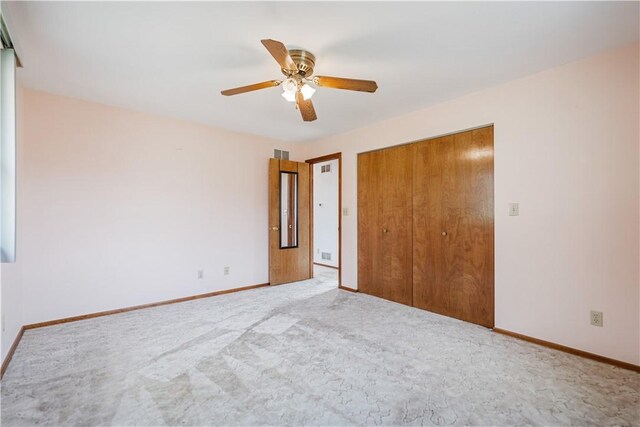 unfurnished bedroom featuring carpet, a closet, and ceiling fan