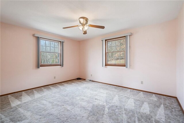 spare room with light carpet, plenty of natural light, and ceiling fan