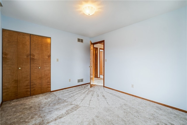 unfurnished bedroom featuring a closet and carpet