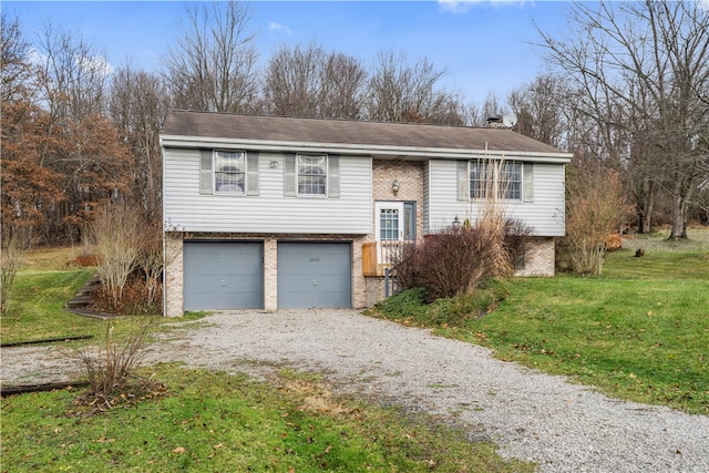 bi-level home featuring a garage and a front lawn