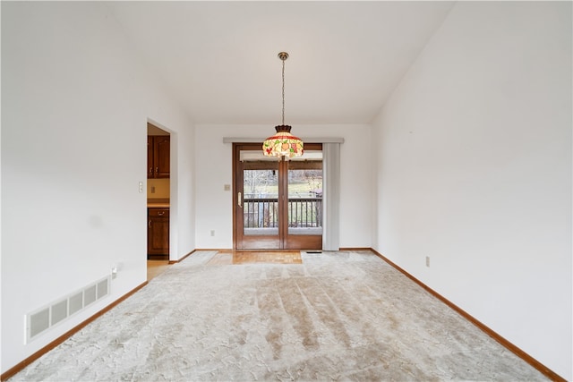 unfurnished dining area featuring lofted ceiling