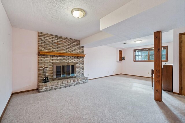 unfurnished living room with light carpet, a textured ceiling, and a brick fireplace