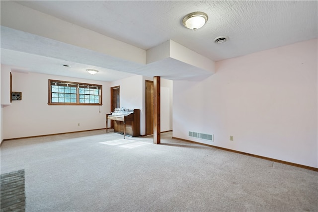 interior space with light carpet and a textured ceiling