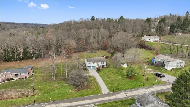 birds eye view of property featuring a view of trees and a rural view