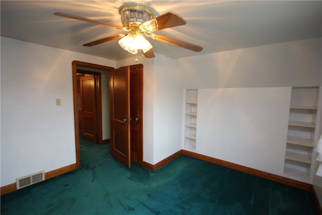 interior space with dark colored carpet and ceiling fan