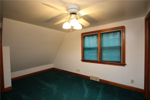 bonus room featuring dark colored carpet, vaulted ceiling, and ceiling fan