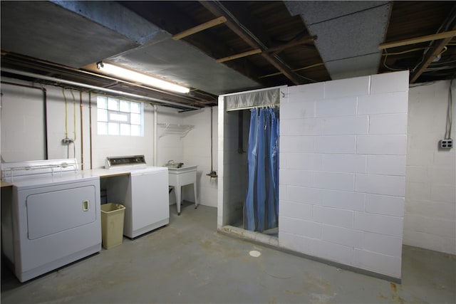 basement with separate washer and dryer and sink