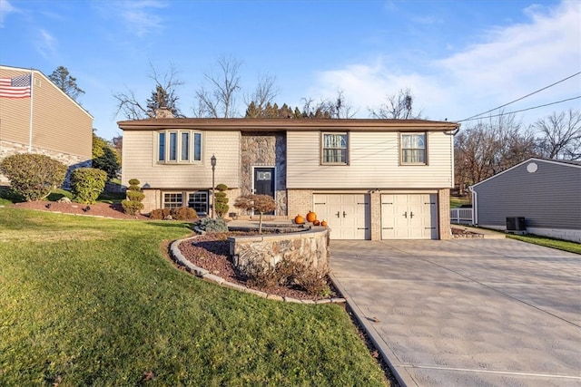 bi-level home featuring central AC, a front lawn, and a garage