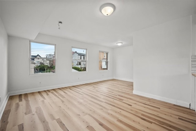 unfurnished room with light wood-type flooring and a healthy amount of sunlight