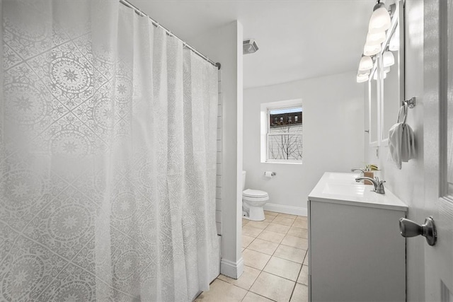 bathroom featuring tile patterned floors, vanity, toilet, and walk in shower