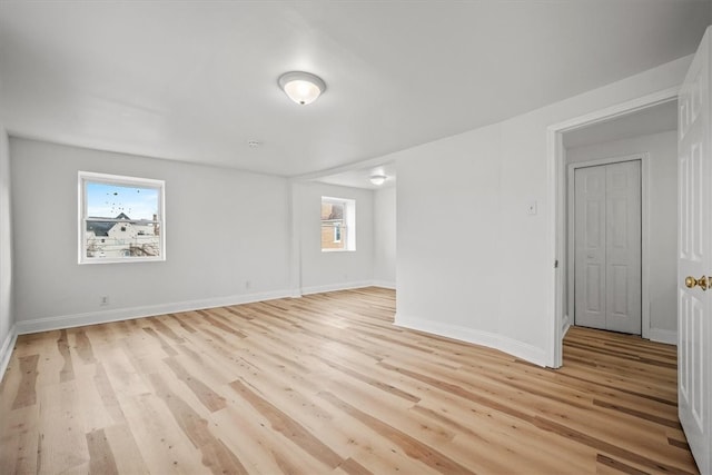 empty room featuring light wood-type flooring and a wealth of natural light