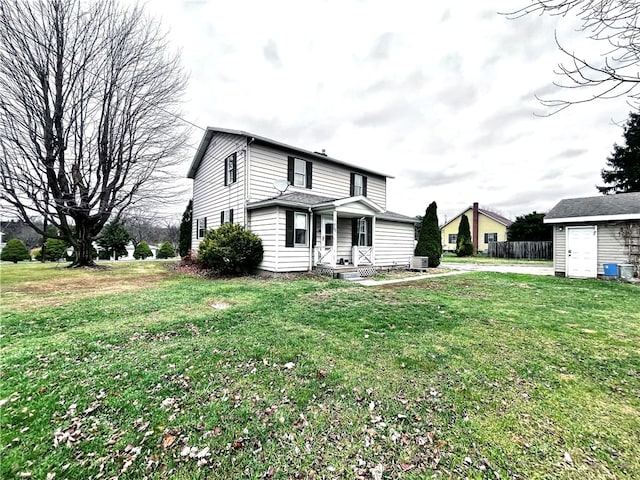 front of property with a shed and a front lawn