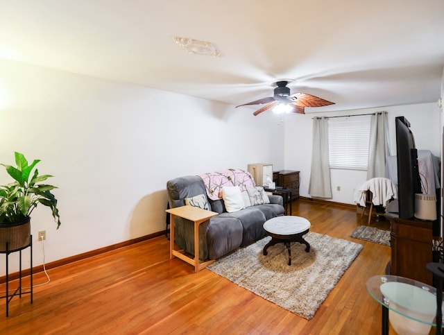 living room with hardwood / wood-style floors and ceiling fan