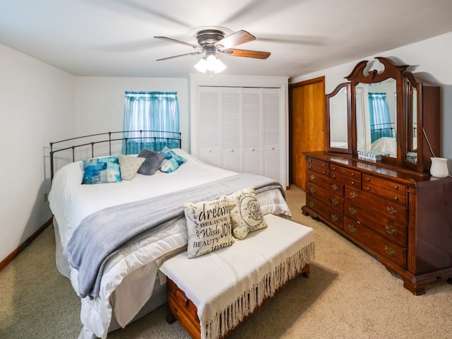 carpeted bedroom featuring ceiling fan and a closet