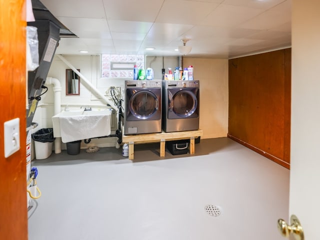 washroom with washer and dryer and sink