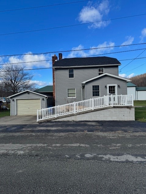 view of front of property with an outdoor structure and a garage