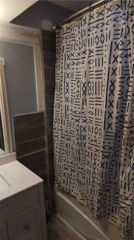 bathroom with shower / bath combo and vanity