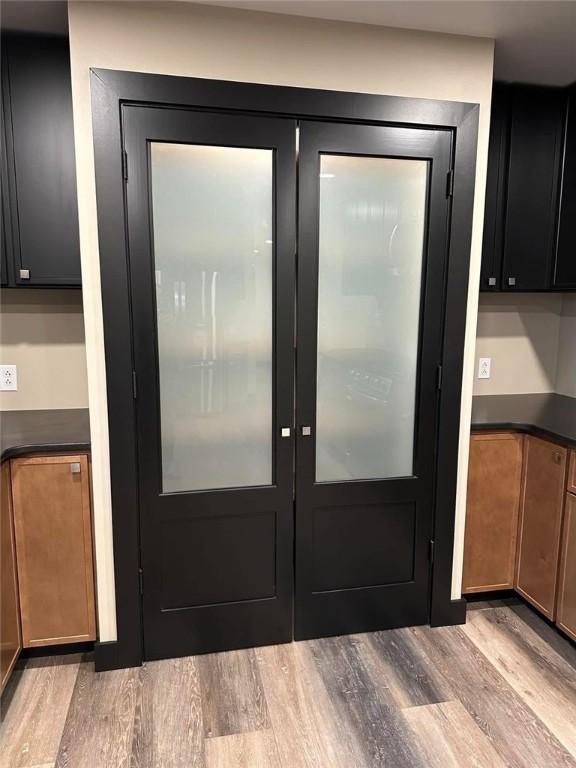 doorway to outside with french doors and light wood-type flooring