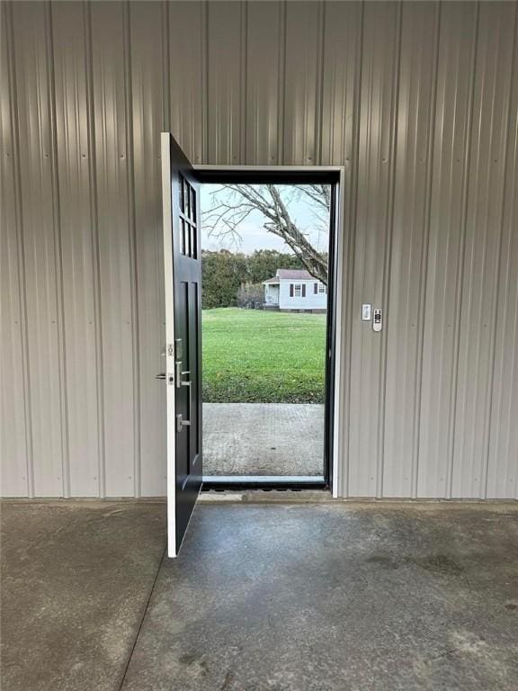 doorway to outside with concrete floors