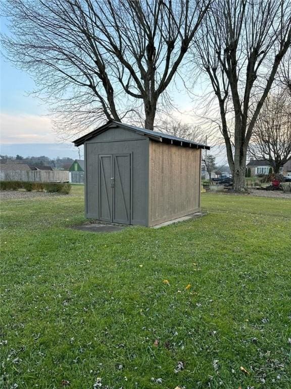 view of outbuilding with a yard