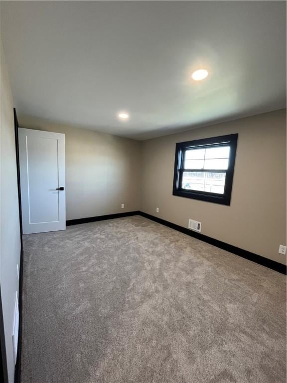 unfurnished room with carpet flooring