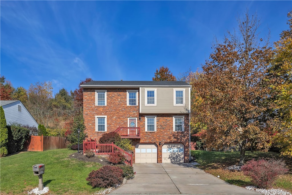 view of front of property with a garage and a front lawn