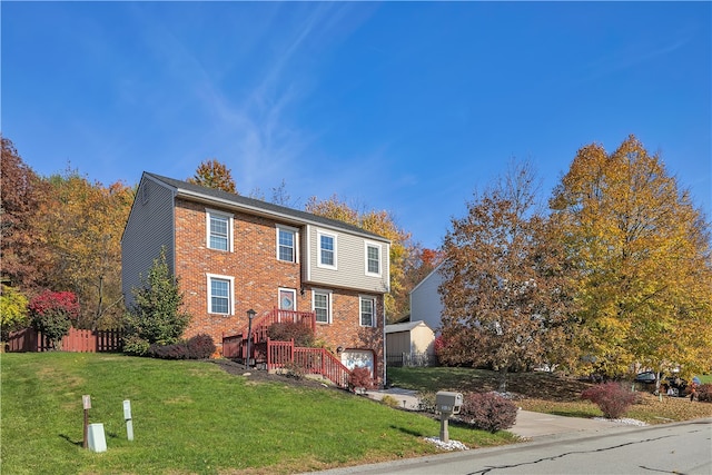 view of front of property with a front yard and a garage