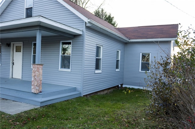 view of side of property with a yard