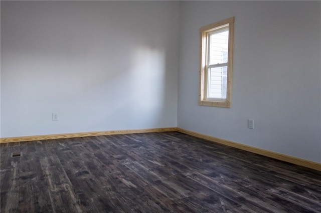 unfurnished room featuring dark wood-type flooring