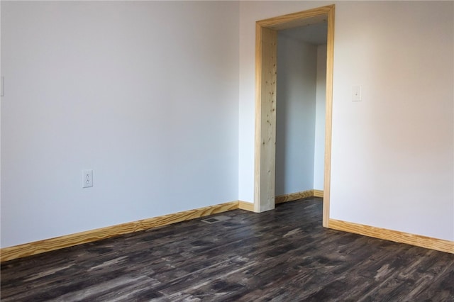 empty room featuring dark wood-type flooring