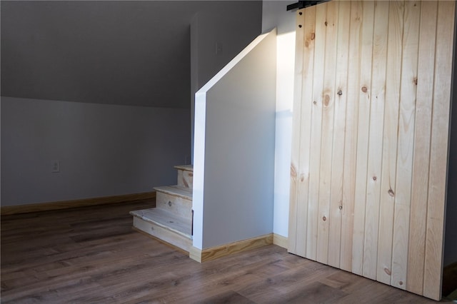 bonus room featuring dark wood-type flooring and lofted ceiling