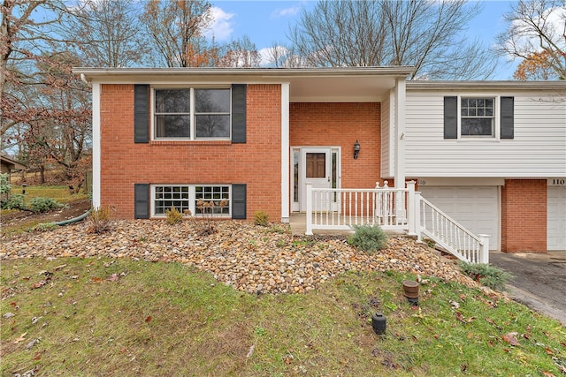 bi-level home with a porch and a garage