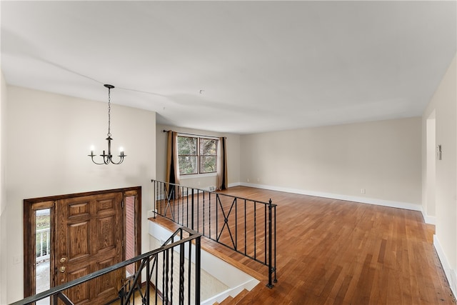 entrance foyer with a chandelier and hardwood / wood-style flooring