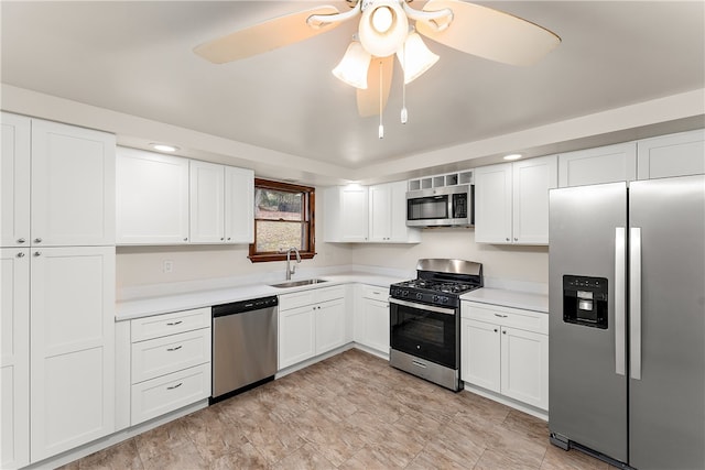 kitchen with ceiling fan, sink, white cabinetry, and stainless steel appliances