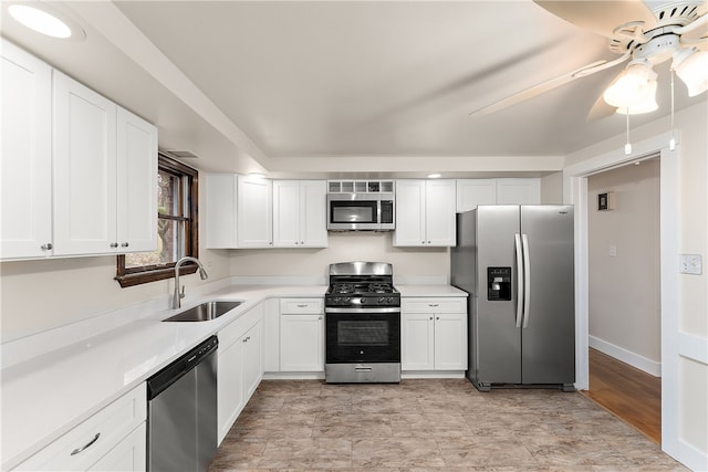 kitchen featuring white cabinets, ceiling fan, sink, and stainless steel appliances