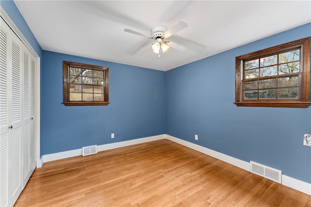 unfurnished bedroom with ceiling fan, a closet, and light hardwood / wood-style floors