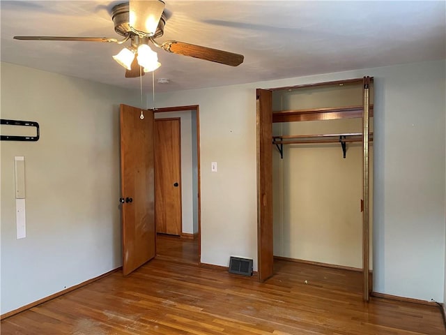 unfurnished bedroom featuring a closet, ceiling fan, and hardwood / wood-style flooring