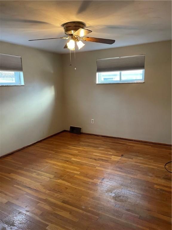 spare room featuring hardwood / wood-style floors and ceiling fan