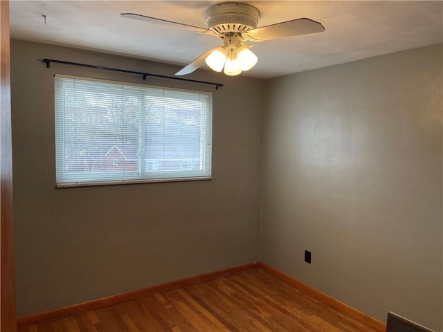 spare room with ceiling fan, plenty of natural light, and hardwood / wood-style flooring