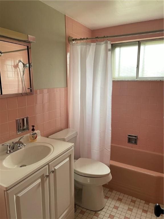 full bathroom with tile patterned floors, vanity, shower / bathtub combination with curtain, tile walls, and toilet