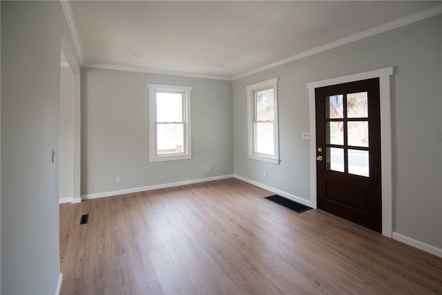 entryway featuring light wood-type flooring and crown molding