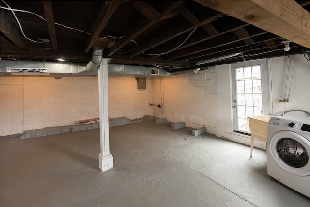 basement featuring electric panel and washer / clothes dryer